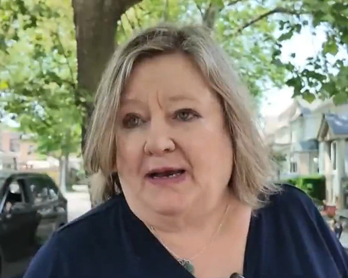 Woman with short blonde hair speaking outside, linked to phone buried in yard and police warning trend Woman with short blonde hair speaking outside, linked to phone buried in yard and police warning trend