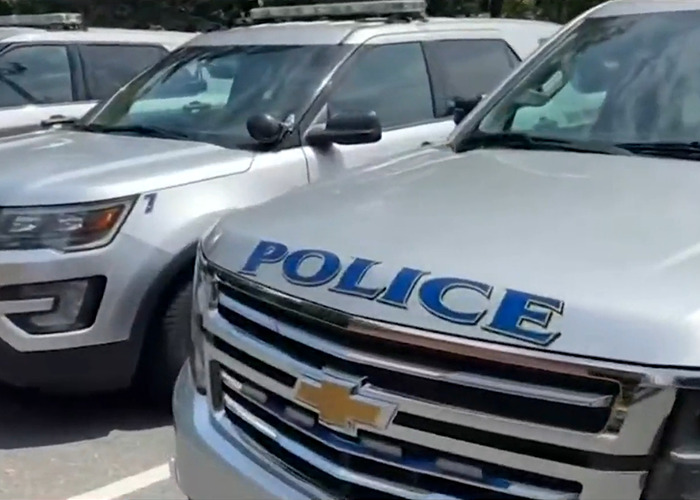 Police vehicles parked closely together as authorities warn of disturbing new trend involving buried phones found by woman in yard Police vehicles parked closely together as authorities warn of disturbing new trend involving buried phones found by woman in yard
