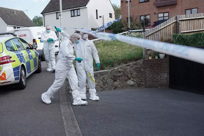 Forensic investigators in protective suits at a residential crime scene related to woman living with deceased parents documentary. - 7
