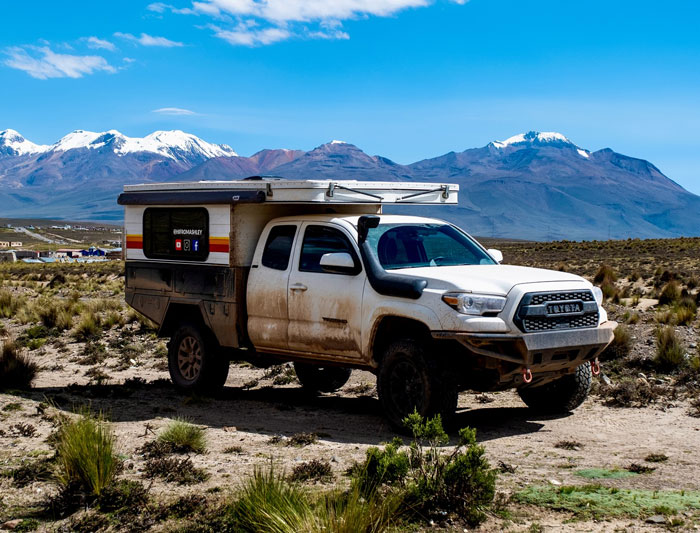 White van parked in a mountainous landscape, symbolizing travel the world in her van and adventurous lifestyle. - 2