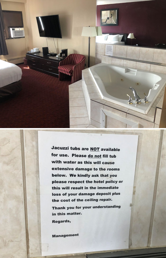 Hotel room with a non-functional jacuzzi tub and a note warning guests not to use it to avoid damage and fees.