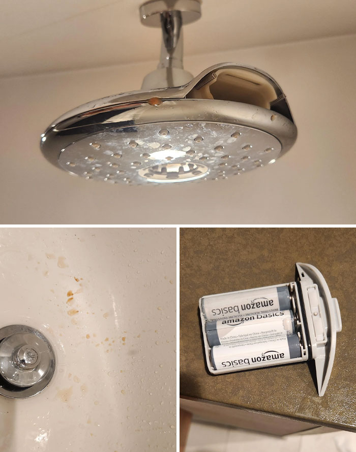 Hotel showerhead with grime, dirty bathtub stains, and a disassembled device with Amazon Basics batteries on a countertop.