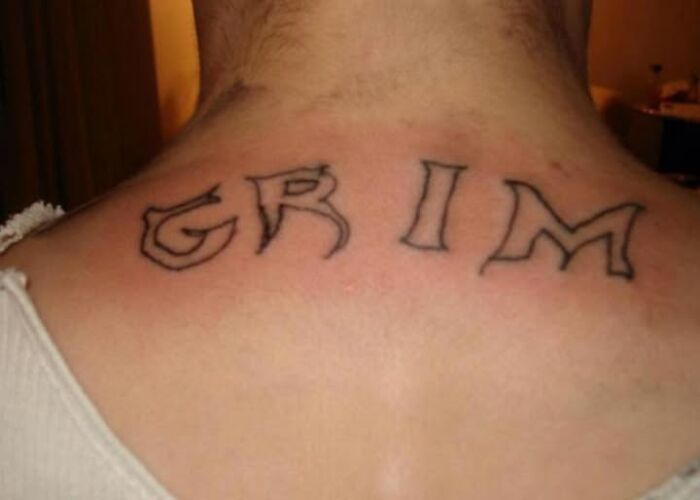 Neck tattoo spelling grim with uneven lines, showcasing one of the worst abysmally bad tattoos on a person's upper back.