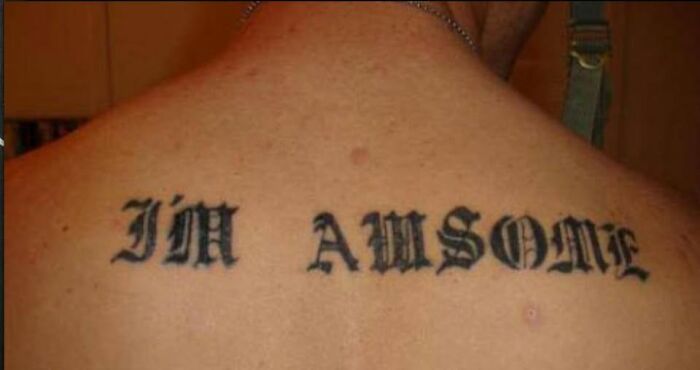 Tattoo on upper back with a misspelled phrase, illustrating one of the worst abysmally bad tattoos shared on Facebook pages.