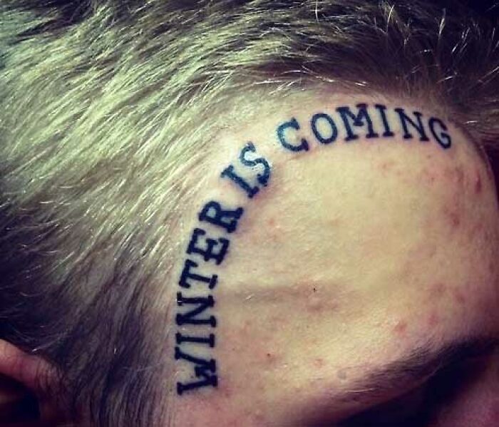 Face tattoo reading "WINTER IS COMING" in bold letters, representing one of the worst tattoos shared on bad tattoo Facebook pages.