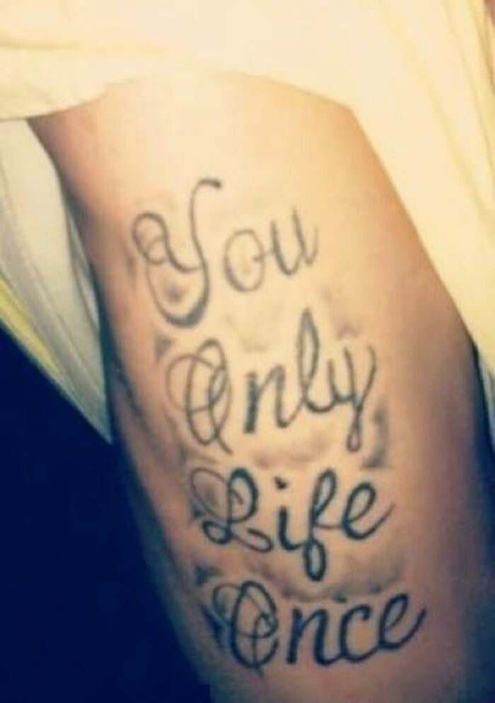 Tattoo on arm with misspelled phrase demonstrating one of the abysmally bad tattoos featured on dedicated Facebook pages.