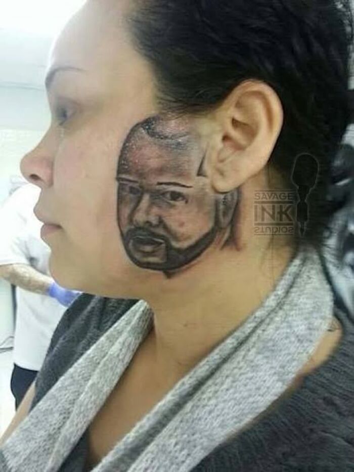 Woman with abysmally bad tattoo of a man's face on her cheek, highlighting poorly executed facial tattoo art.