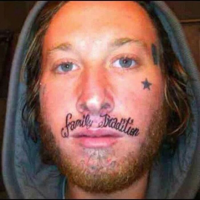 Close-up of a man with a poorly done face tattoo reading family tradition, showcasing one of the worst bad tattoos.