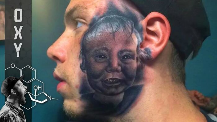 Man with a large, abysmally bad tattoo of a distorted baby face covering the side of his neck and cheek.