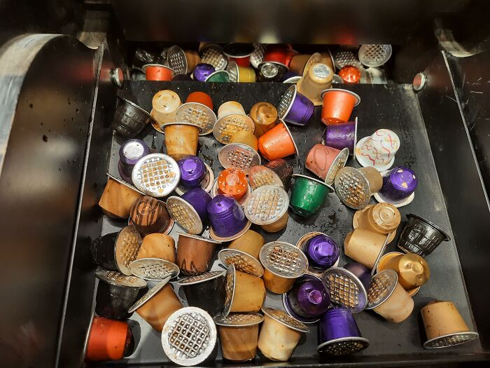 Used coffee pods piled inside a container, illustrating trends leading to overconsumption and environmental waste concerns. - 4