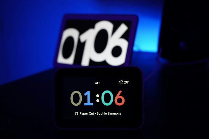 Digital clocks displaying time in a dark room with people share things improved life mood lighting and music details. - 25