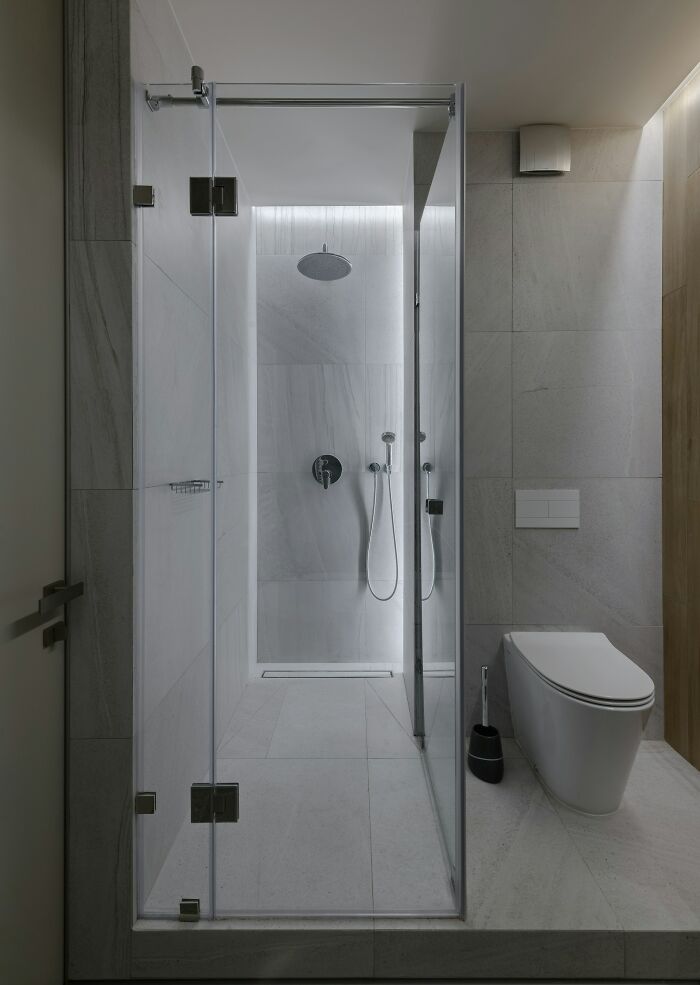 Modern bathroom with glass shower enclosure and toilet, illustrating extreme parents punishing their kids way too far.