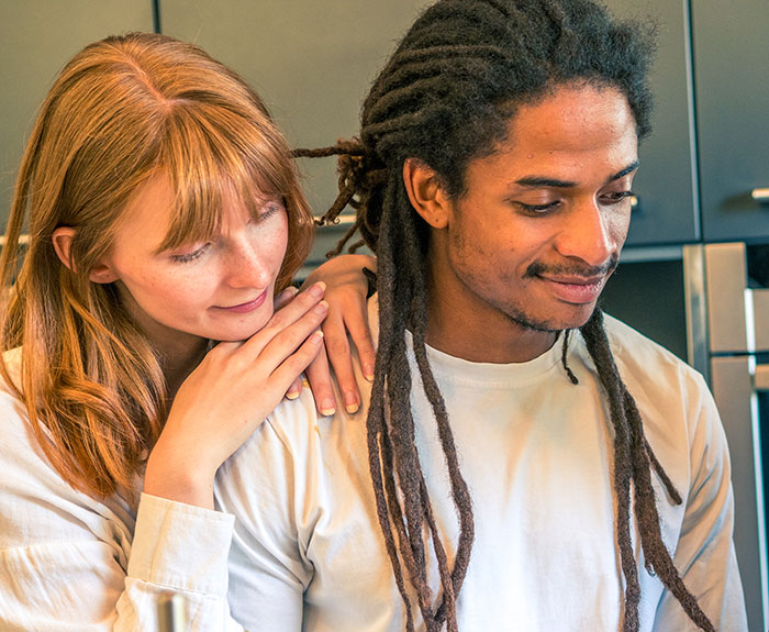 Woman looking shocked while hearing nicknames her brother has from his wife in a kitchen setting with warm lighting Woman looking shocked while hearing nicknames her brother has from his wife in a kitchen setting with warm lighting