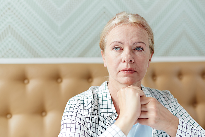 Woman looking shocked and thoughtful, reflecting emotions after discovering mother-in-law's hatred following husband's death - 1