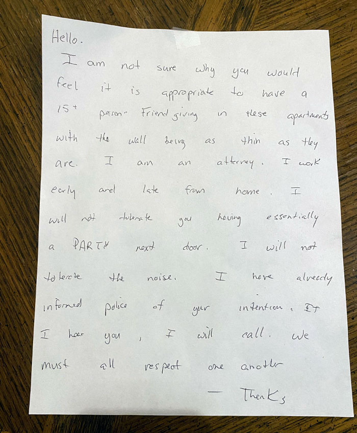 Handwritten unhinged neighbor’s note warning against noisy parties in an apartment with thin walls, showing tense tenant relations.