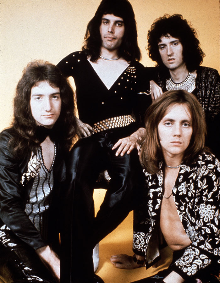 Freddie Mercury and Queen band members posing for a vintage photo highlighting Freddie Mercury love child controversy.