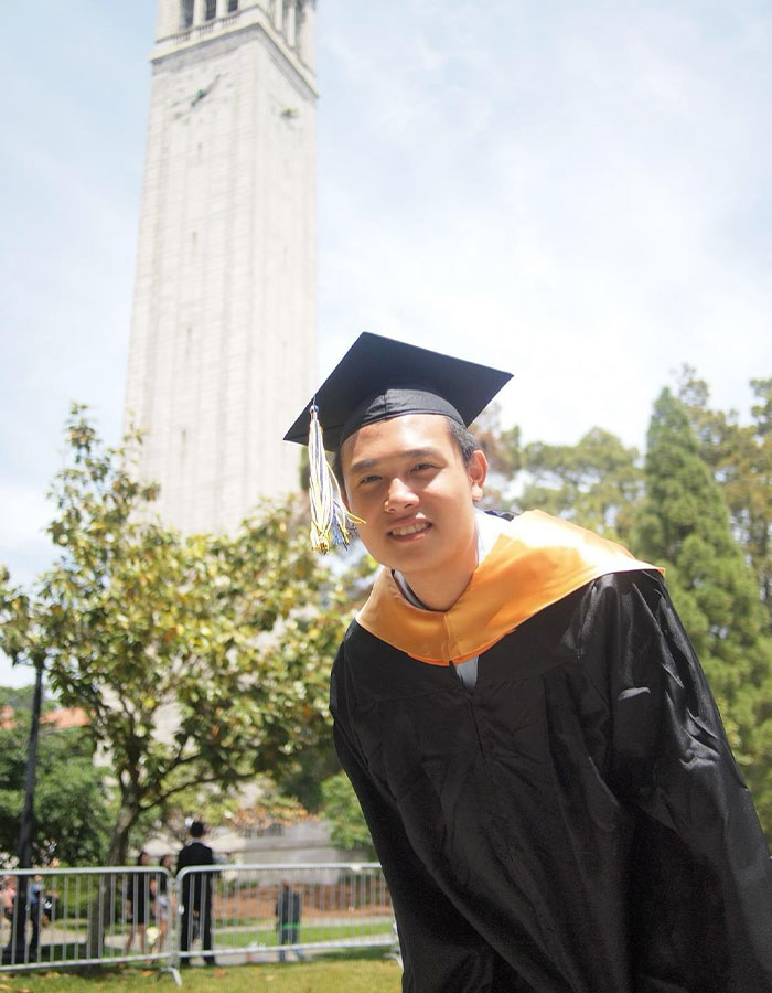 Image shows a young man in a graduation cap and gown smiling outdoors, unrelated to vaping on plane incident.