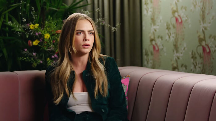 Actress sitting on a couch during an interview about celebrities Hollywood tried to make leading A-listers.