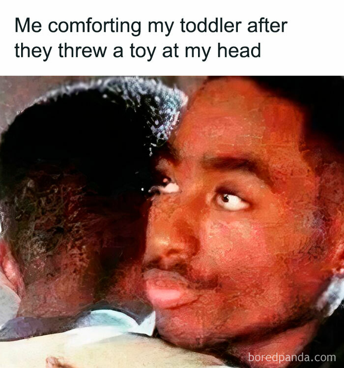 Parent comforting toddler after being hit with a toy, capturing the reality of being a cool mom in parenting memes.