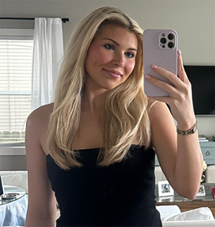 Young woman taking a selfie indoors, relating to heated debate after passenger slams woman for refusing to watch her bag in airport. Young woman taking a selfie indoors, relating to heated debate after passenger slams woman for refusing to watch her bag in airport.