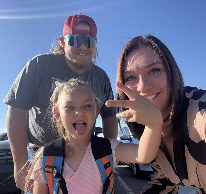 Family with child outdoors, smiling and posing together, illustrating family awarded nearly a billion dollars case.