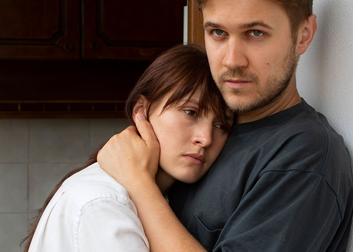 Worried woman being comforted by partner, reflecting fear and uncertainty about poisoning and pregnancy concerns. Worried woman being comforted by partner, reflecting fear and uncertainty about poisoning and pregnancy concerns.