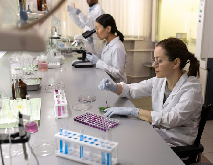 Scientists in lab coats conducting experiments to identify the critical point when the body starts to age rapidly Scientists in lab coats conducting experiments to identify the critical point when the body starts to age rapidly