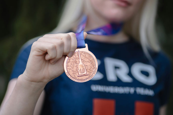 Close-up of a person holding a bronze medal, showcasing an impressive family flex moment of achievement and pride.