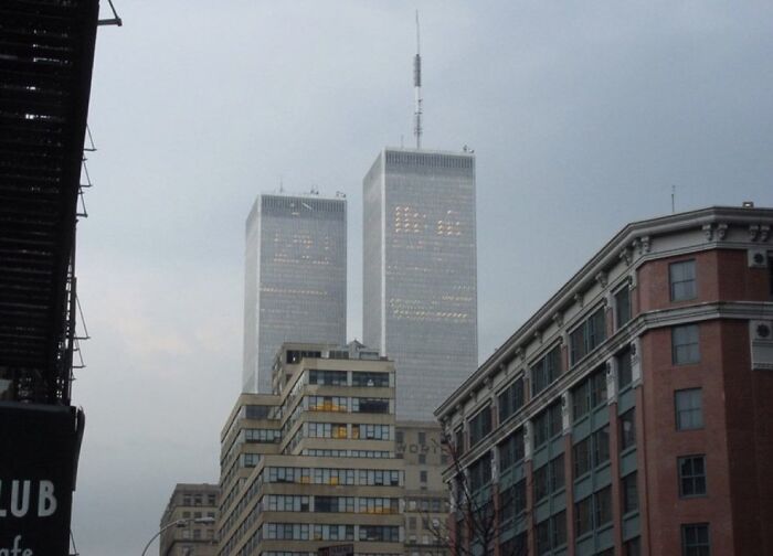 Twin Towers rising above city buildings at dusk, capturing an unsettling image linked to morbid knowledge online group.