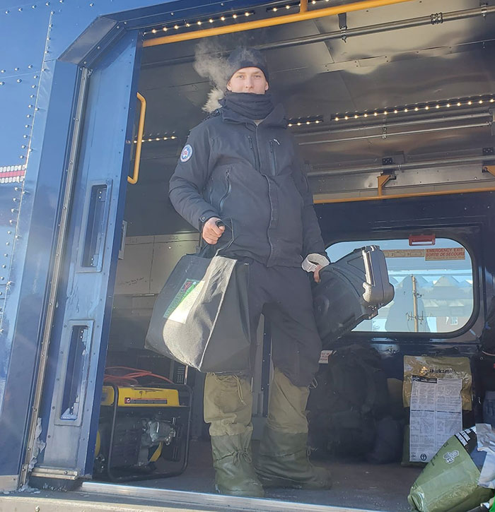 Man dressed in hiking gear carrying bags and gear inside a vehicle related to lone hiking and search efforts