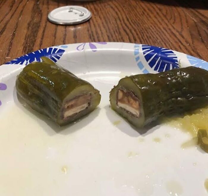 Unusual food on a paper plate showing stuffed pickles, highlighting risky foods for physical and mental health.