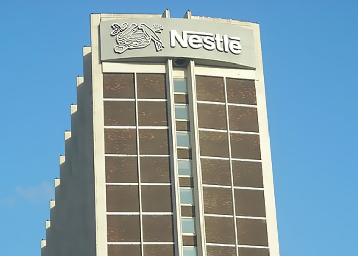 Nestle corporate building under clear blue sky representing jobs that only a person without a soul would do.