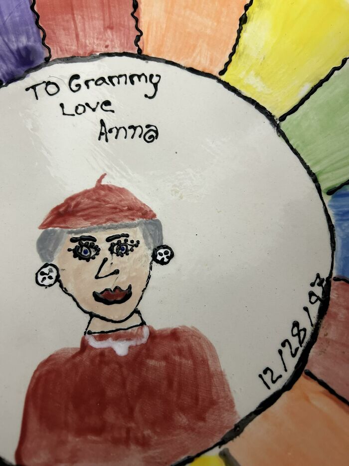 Hand-painted DIY craft plate with a drawing of a woman, colorful border, and handwritten message to Grammy.