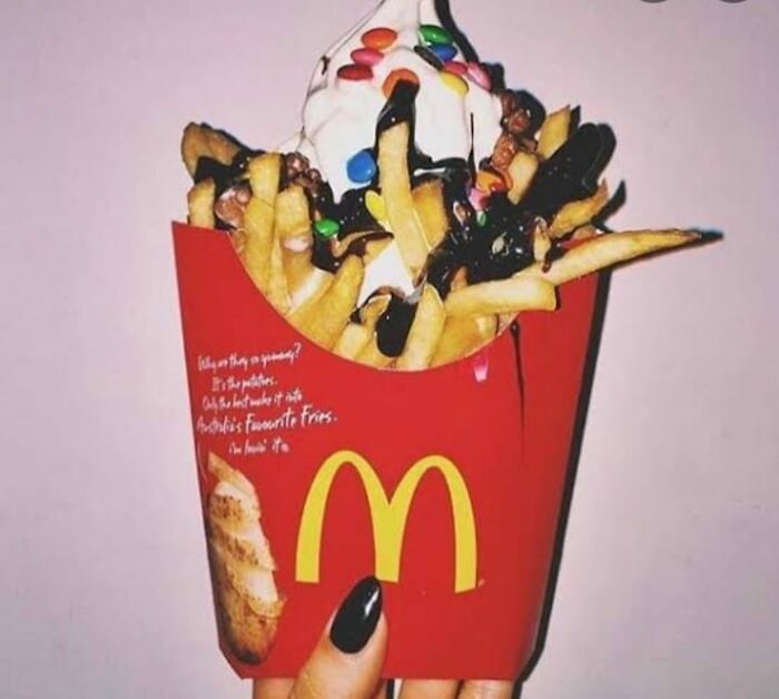 McDonald's fries topped with ice cream, chocolate syrup, and colorful candy, a food nobody should eat for health.