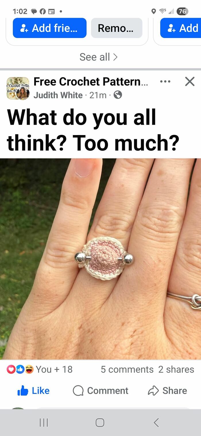 Hand wearing a crochet ring with a metal bar, example of horrendous DIY projects from craft shaming collection.