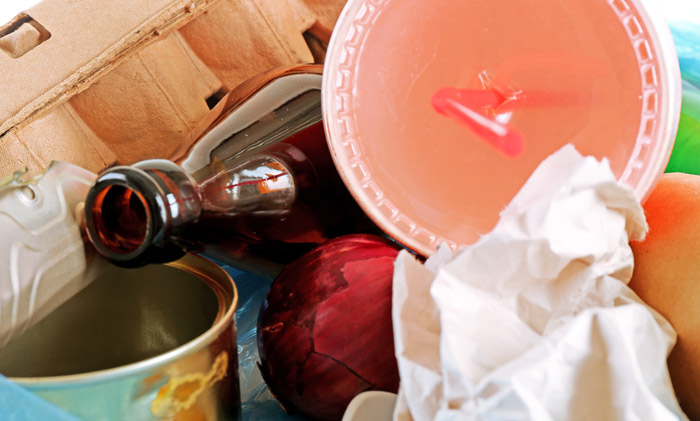 Close-up of trash and recyclables illustrating professionals who work in other people’s homes encountering unusual messes.