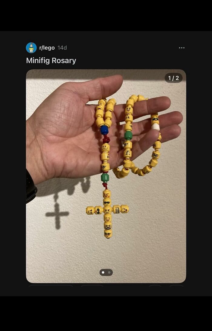 Hand holding a DIY craft shaming minifig rosary made from yellow Lego heads with varied facial expressions.