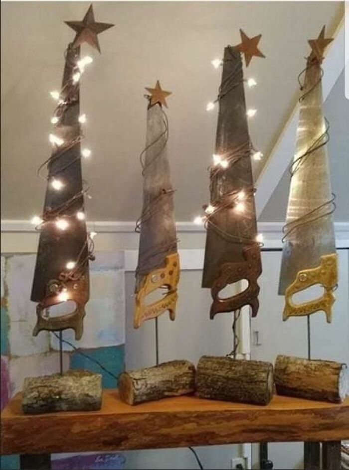 Rusty saw blades decorated with lights and stars, mounted on wood logs as a craft shaming DIY project display.