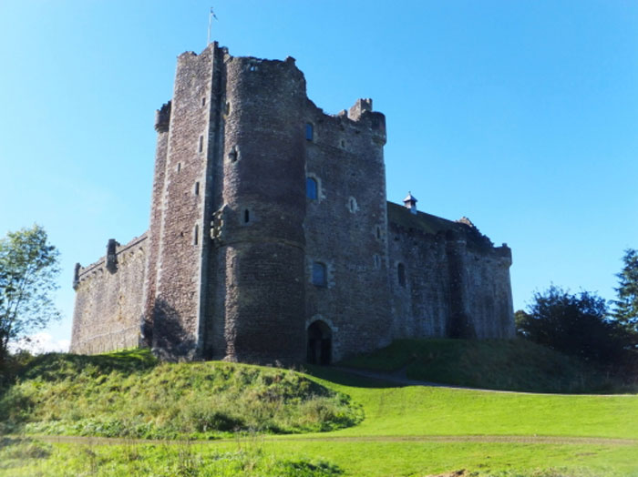 Historic castle venue on a bright day, representing an extravagant and unhinged wedding spend location. - 7