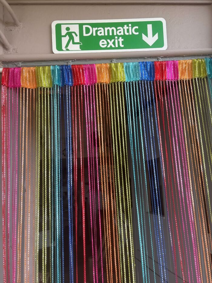 Colorful beaded curtain decor piece hanging below a dramatic exit sign enhancing home interiors.