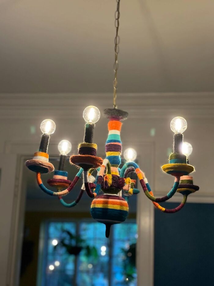 Colorful chandelier wrapped in vibrant yarn, a unique decor piece adding a magical touch to home interiors.