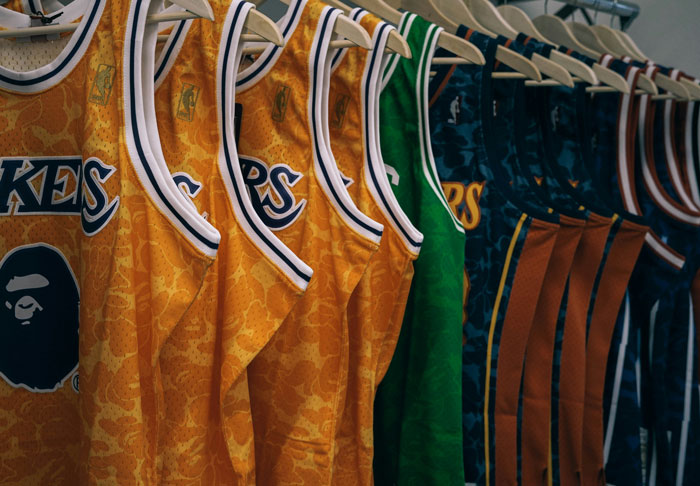 Basketball jerseys hanging on a rack, illustrating one of the things Americans do that make them stand out abroad.
