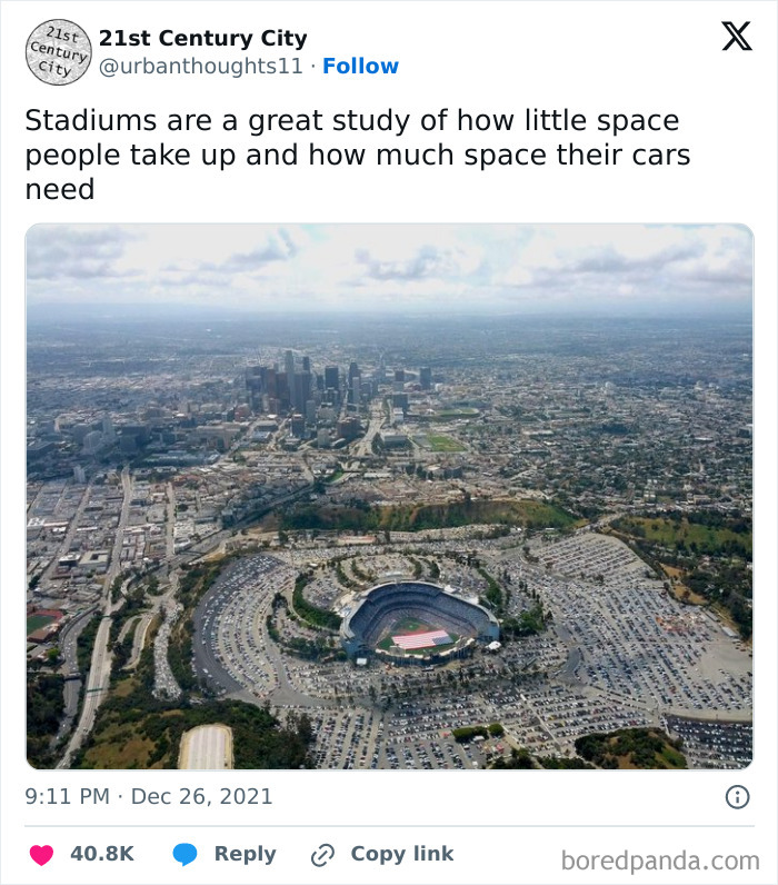 Aerial view of a stadium surrounded by extensive parking in a sprawling urban area highlighting lack of affordable housing.