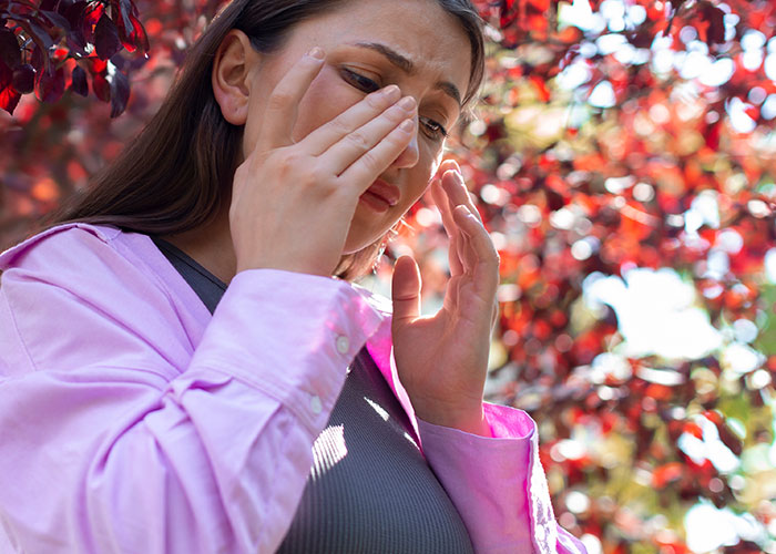 Young woman outdoors looking regretful and emotional, illustrating wild and embarrassing drinking stories and poor decisions.