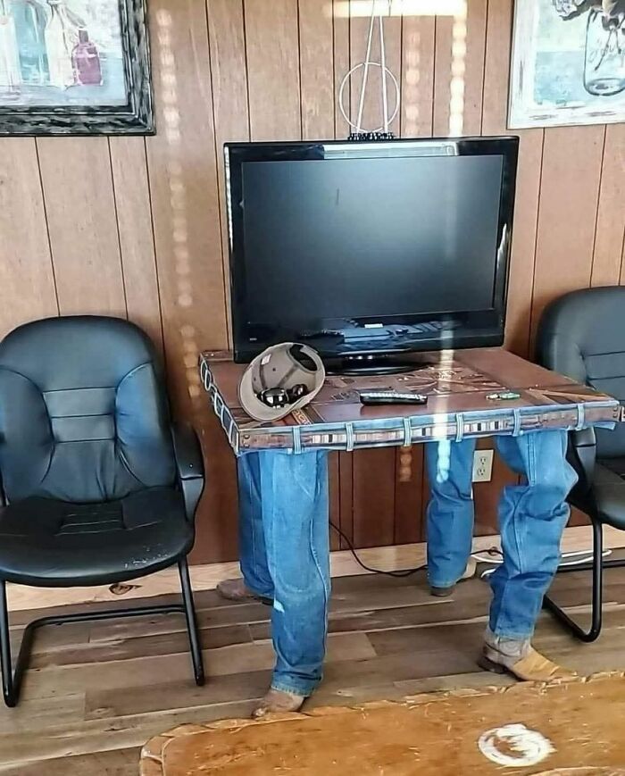 TV stand DIY project with jeans legs and boots, showcasing a craft shaming example of a horrendous DIY project.