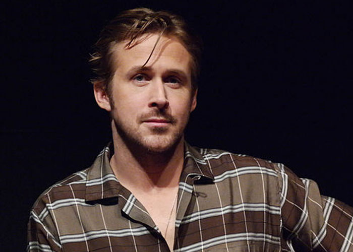 Actor Ryan Gosling in a brown plaid shirt, captured during a casual moment, showcasing a total gentleman vibe.