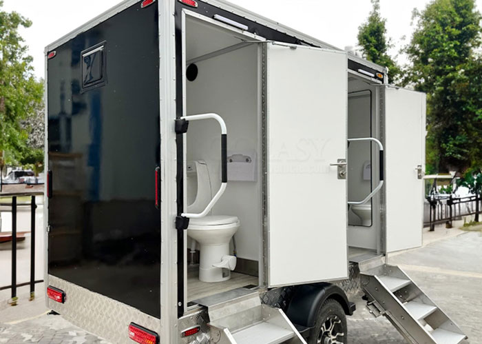 Portable luxury restroom trailer with open doors at outdoor event, illustrating unhinged wedding spends and extravagant costs. - 3