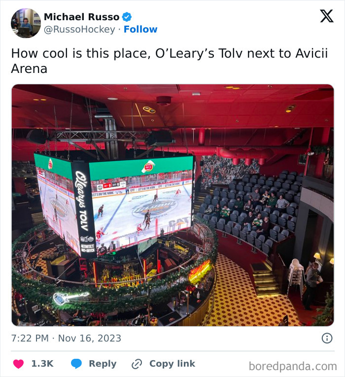 Interior of O’Leary’s Tolv bar next to Avicii Arena with a large hanging screen showing a hockey game and unique seating.