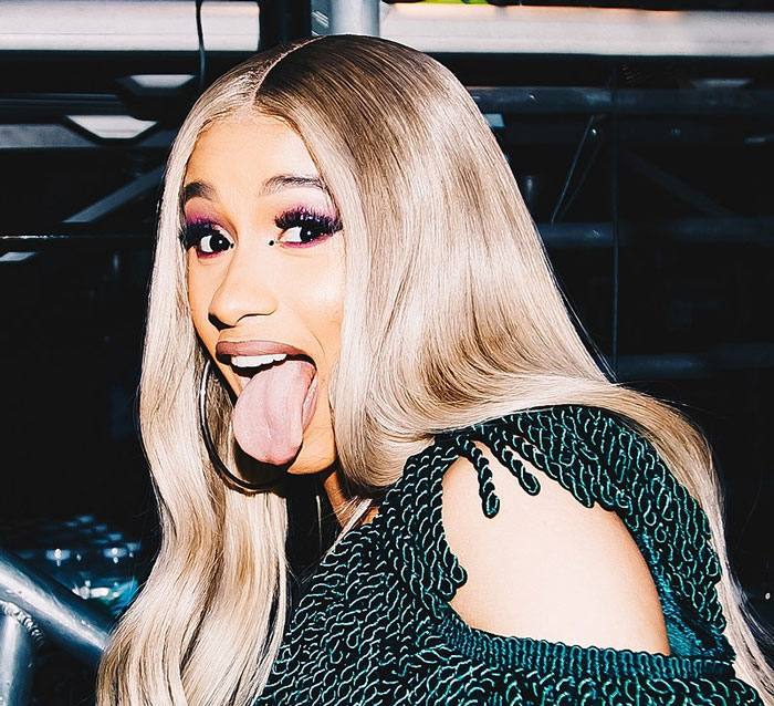 A woman with long blonde hair and bold makeup making a playful face, representing unhinged wedding spends. - 41