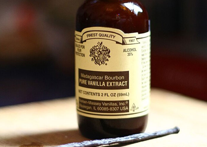 Bottle of Madagascar Bourbon vanilla extract on a wooden surface representing horrifying facts about everyday items.